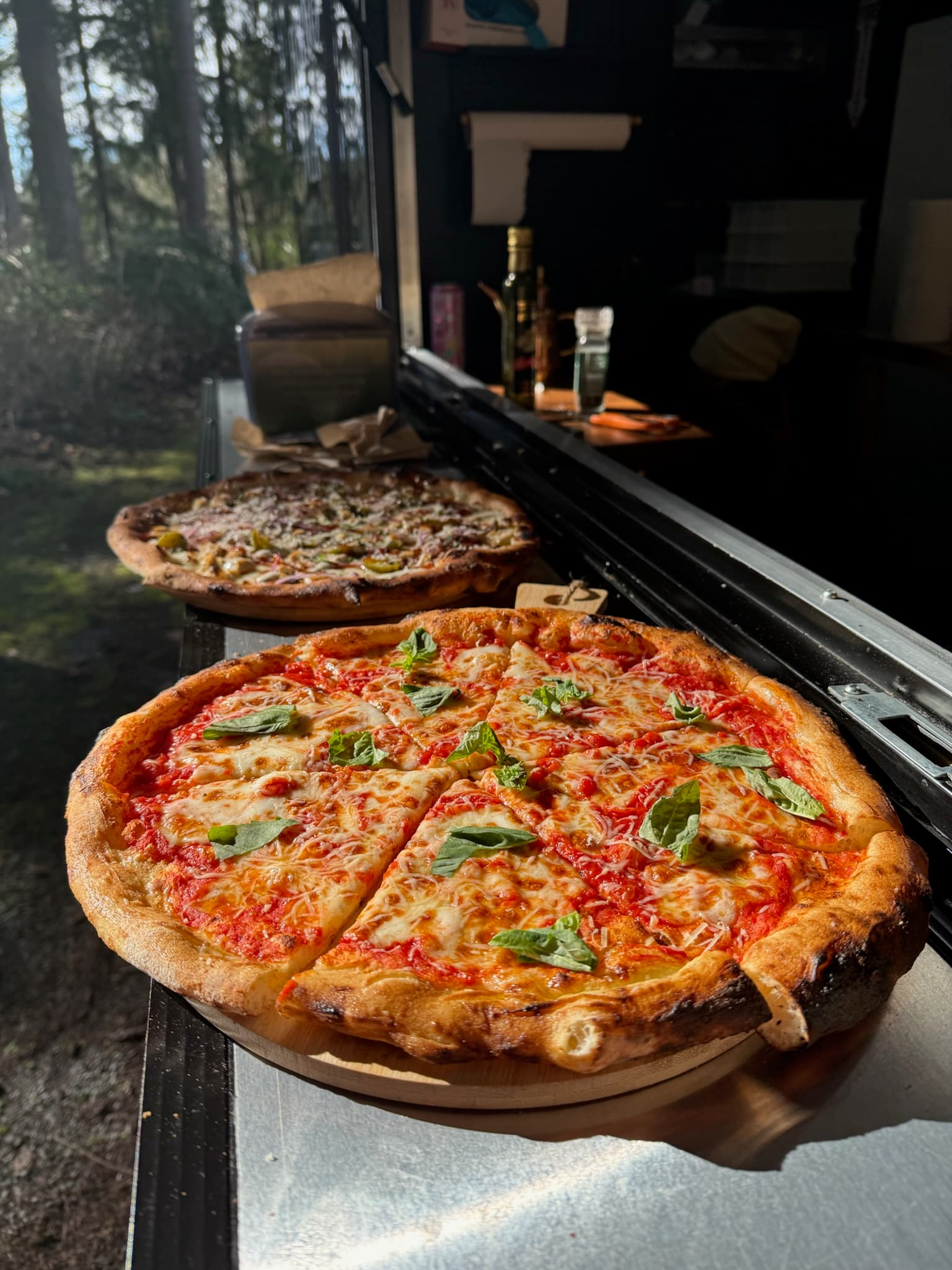 Neapolitan pizza fresh from the wood-fired oven with charred crust and melted mozzarella