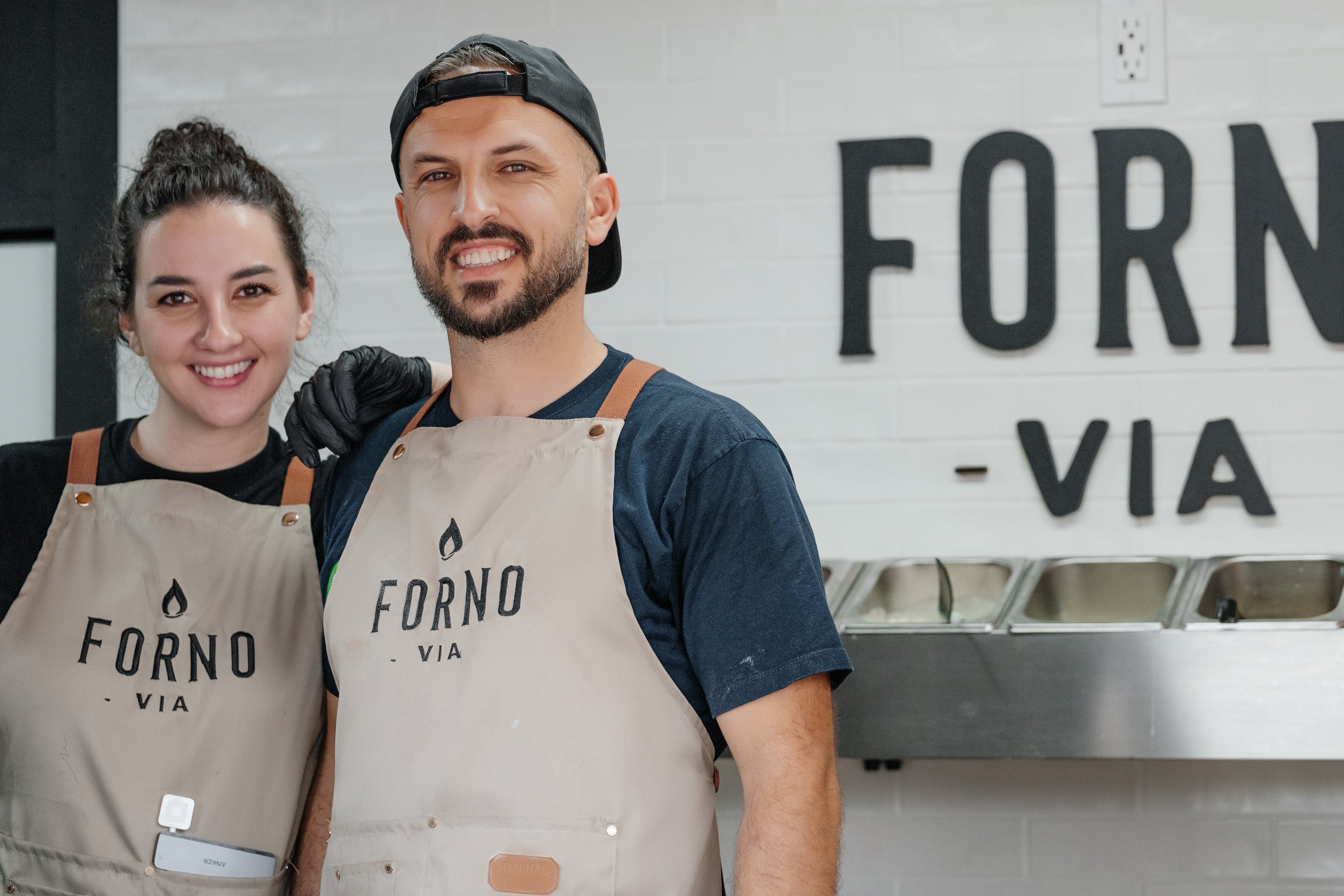 Guests gathered around the Forno Via trailer at a catered corporate event in Seattle