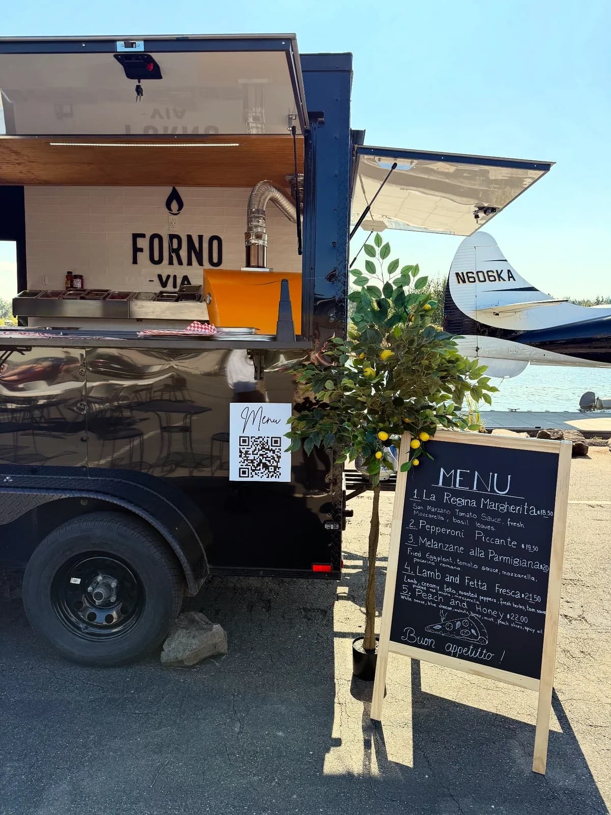 Forno Via mobile pizza trailer and menu board set up for service