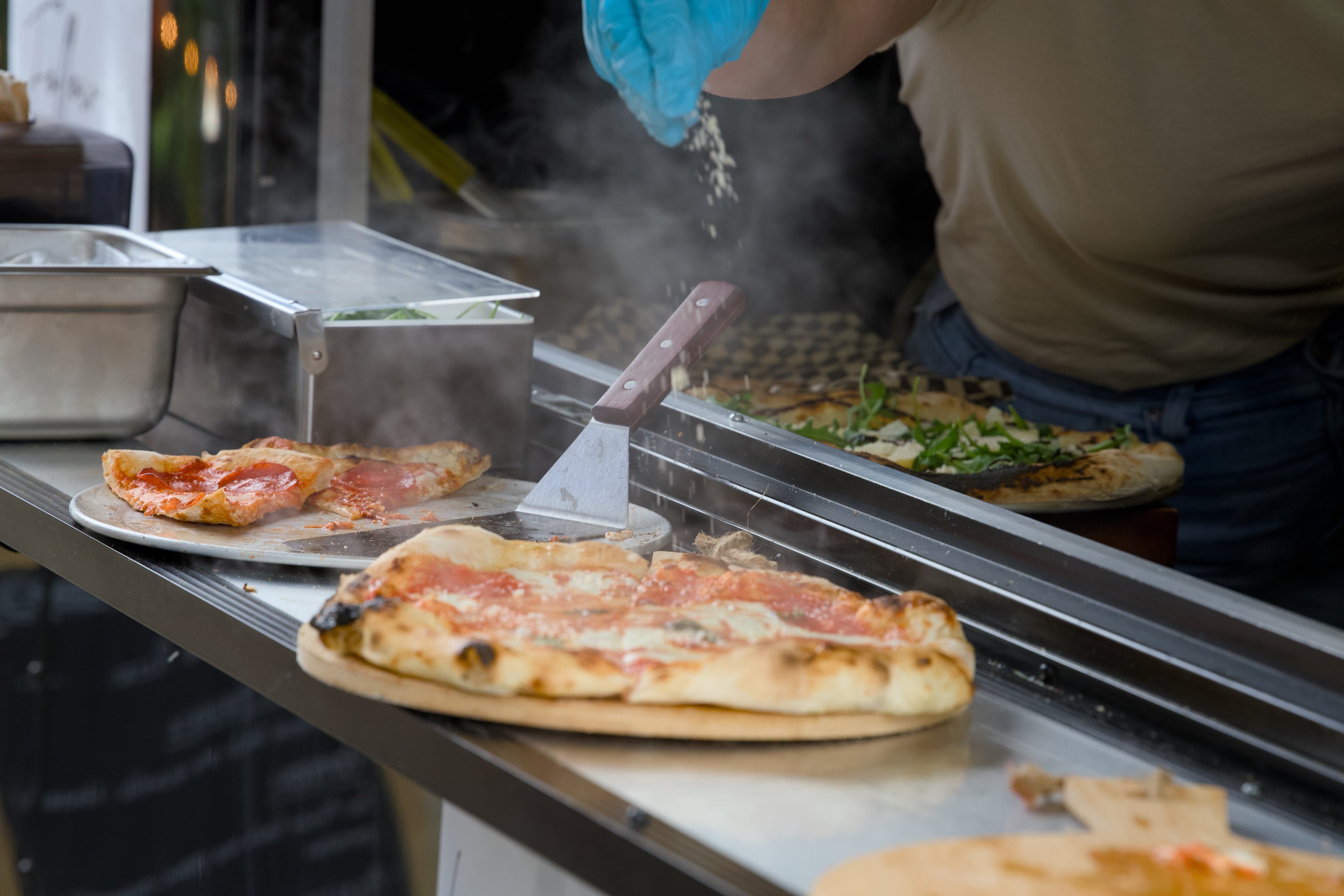 Forno Via wood-fired pizza trailer in action at an event